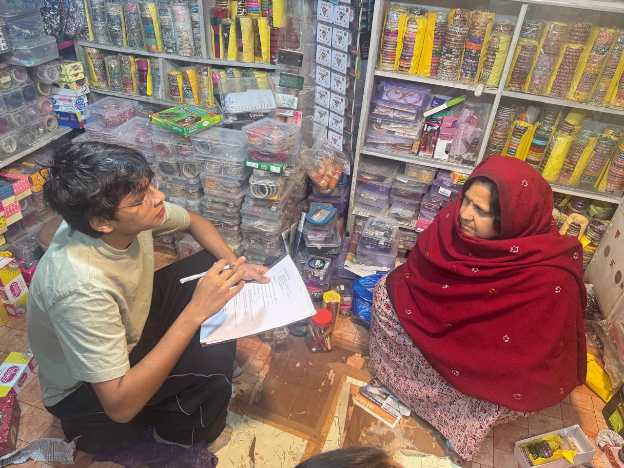 Aarav interviewing a woman shopkeeper in her bangle shop