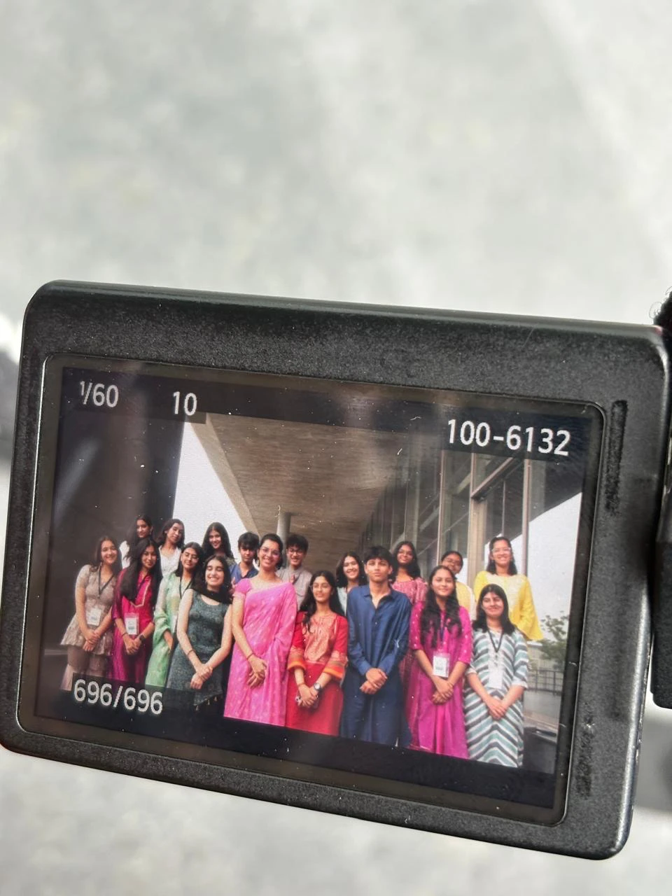 Group photo of the NMMUN 2025 team shown on a camera screen